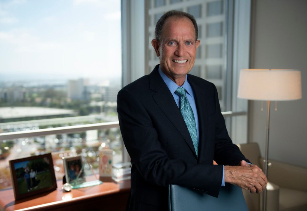 A trustee stands by his desk
