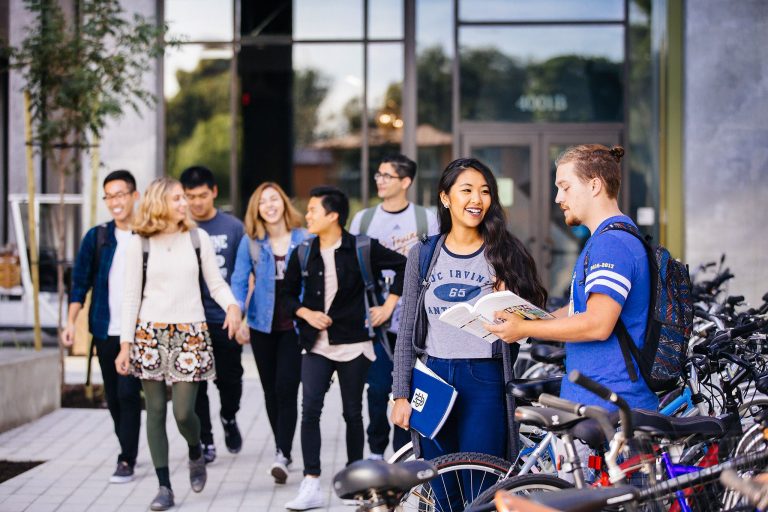 Students stand outside a building
